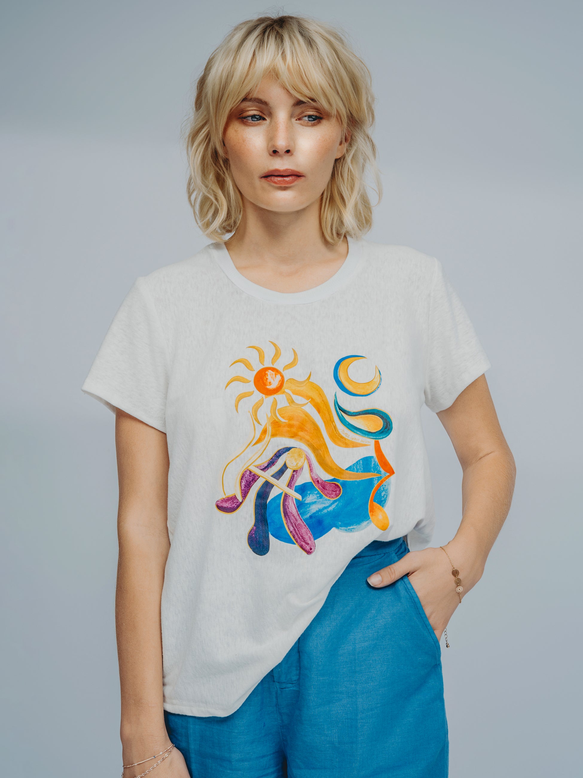 Model wearing Chroma T-shirt styled with resort wear blue shorts - editorial luxury fashion