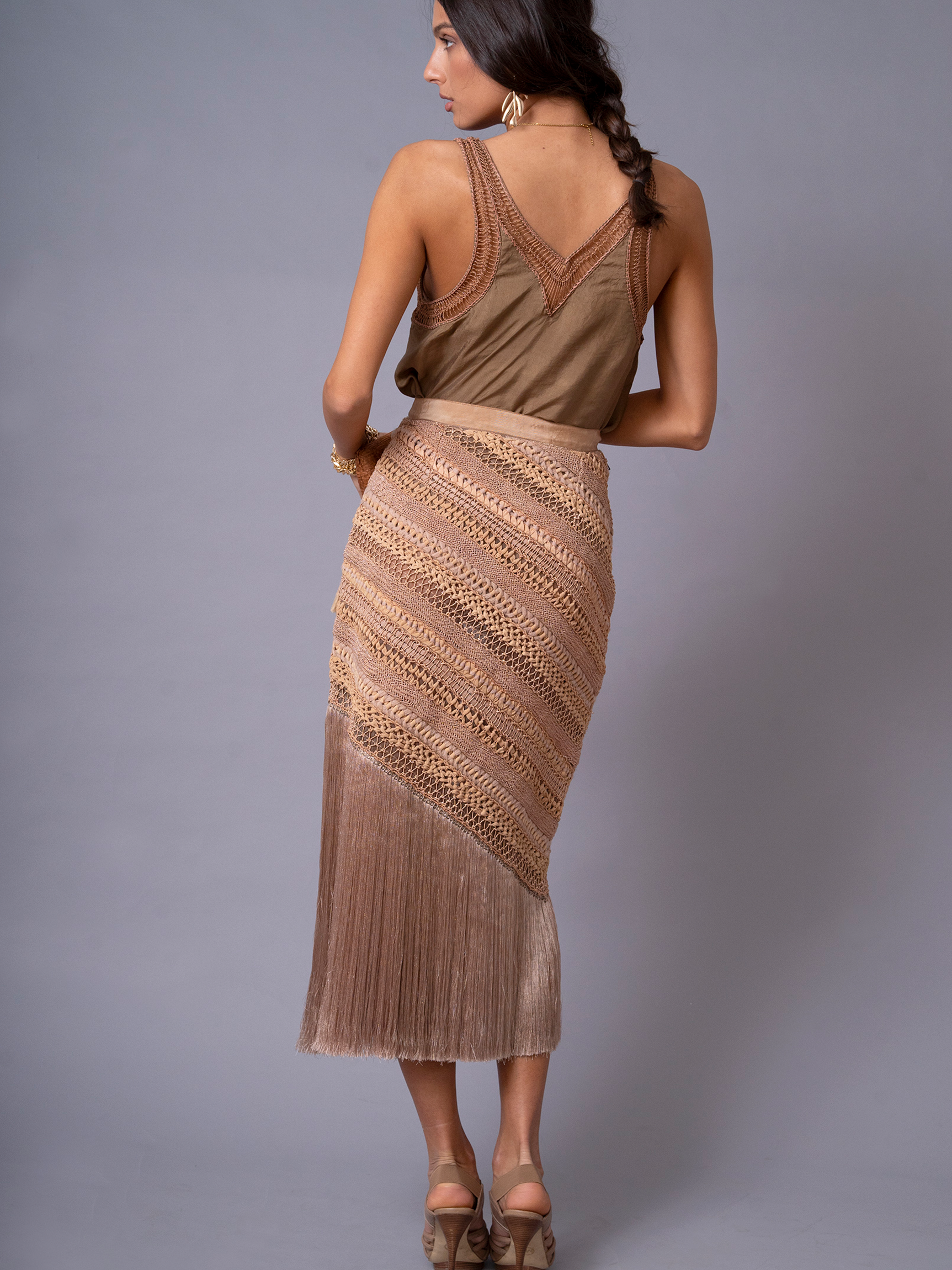 Back view of OCHRIDIA Fringe Skirt showing flowing rayon fringe detail in earthy brown