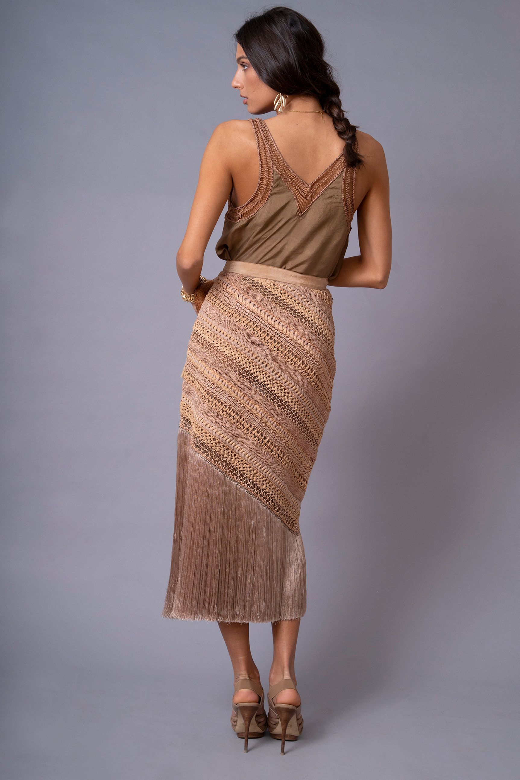 Back view of OCHRIDIA Fringe Skirt showing flowing rayon fringe detail in earthy brown