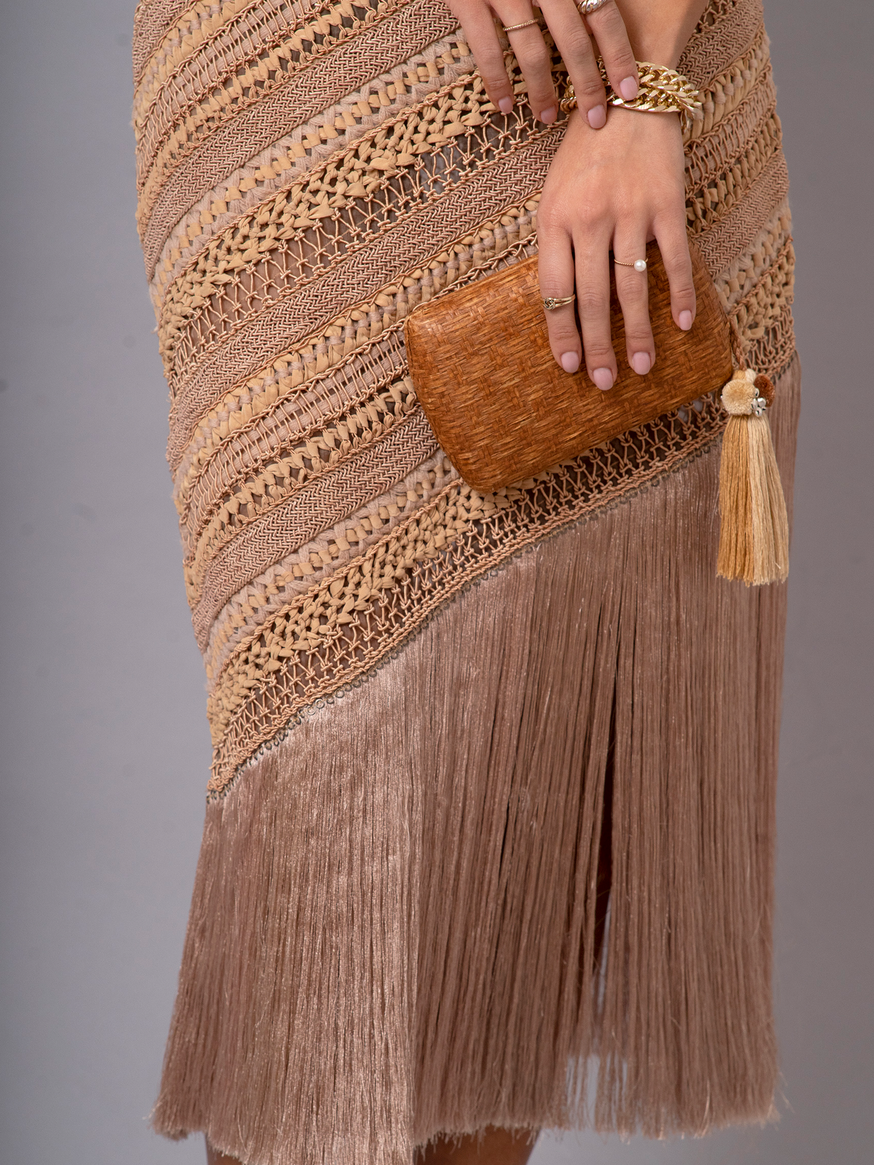 Close-up of full-length view of OCHRIDIA Fringe Skirt in earthy brown with silky fringe detailing.