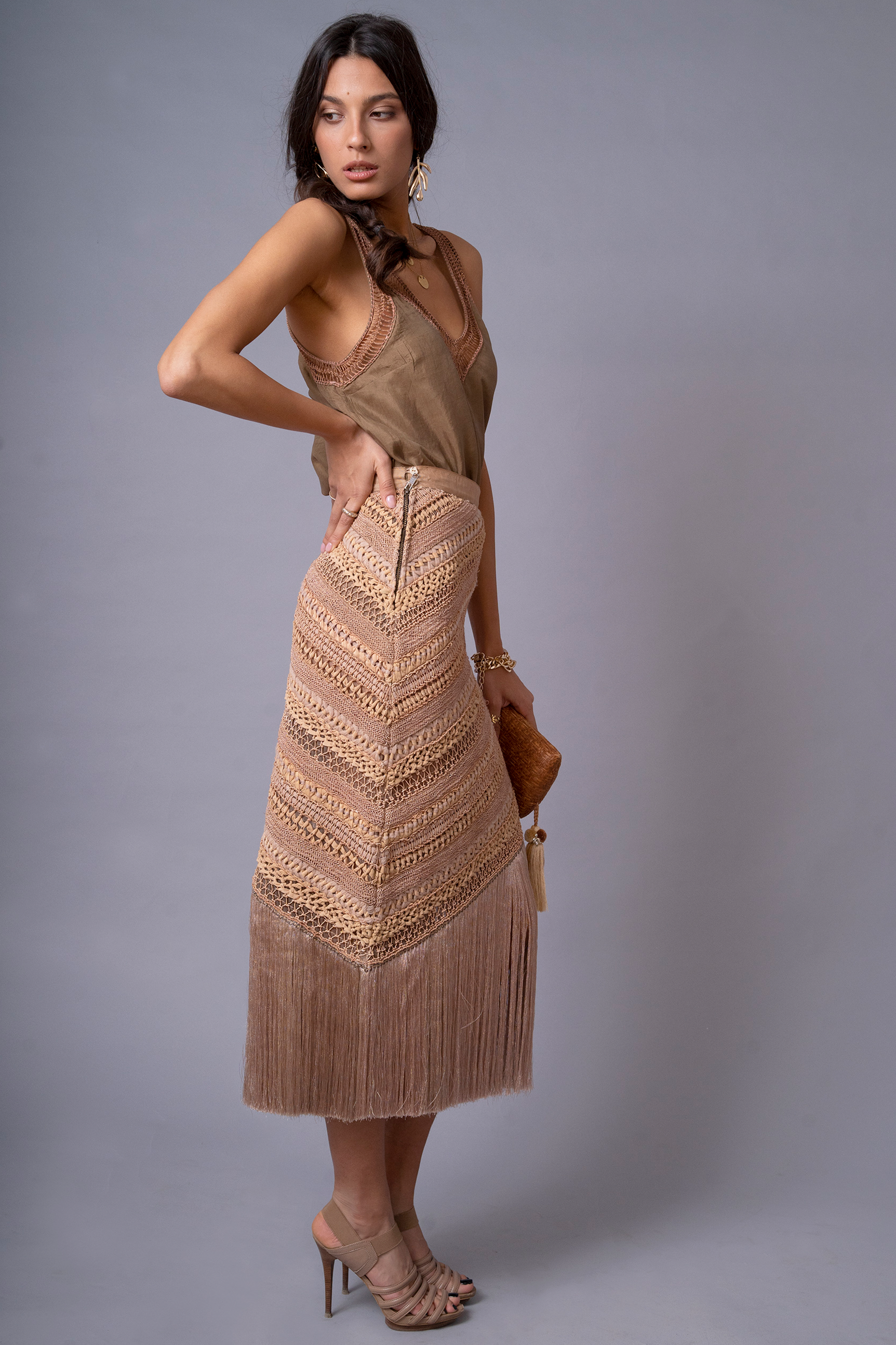 Side profile of model wearing OCHRIDIA Fringe Skirt highlighting silhouette and fringe movement