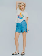 Model wearing the Chroma T-shirt in white, with vibrant print - luxury resort wear by Nina Aprés Swim