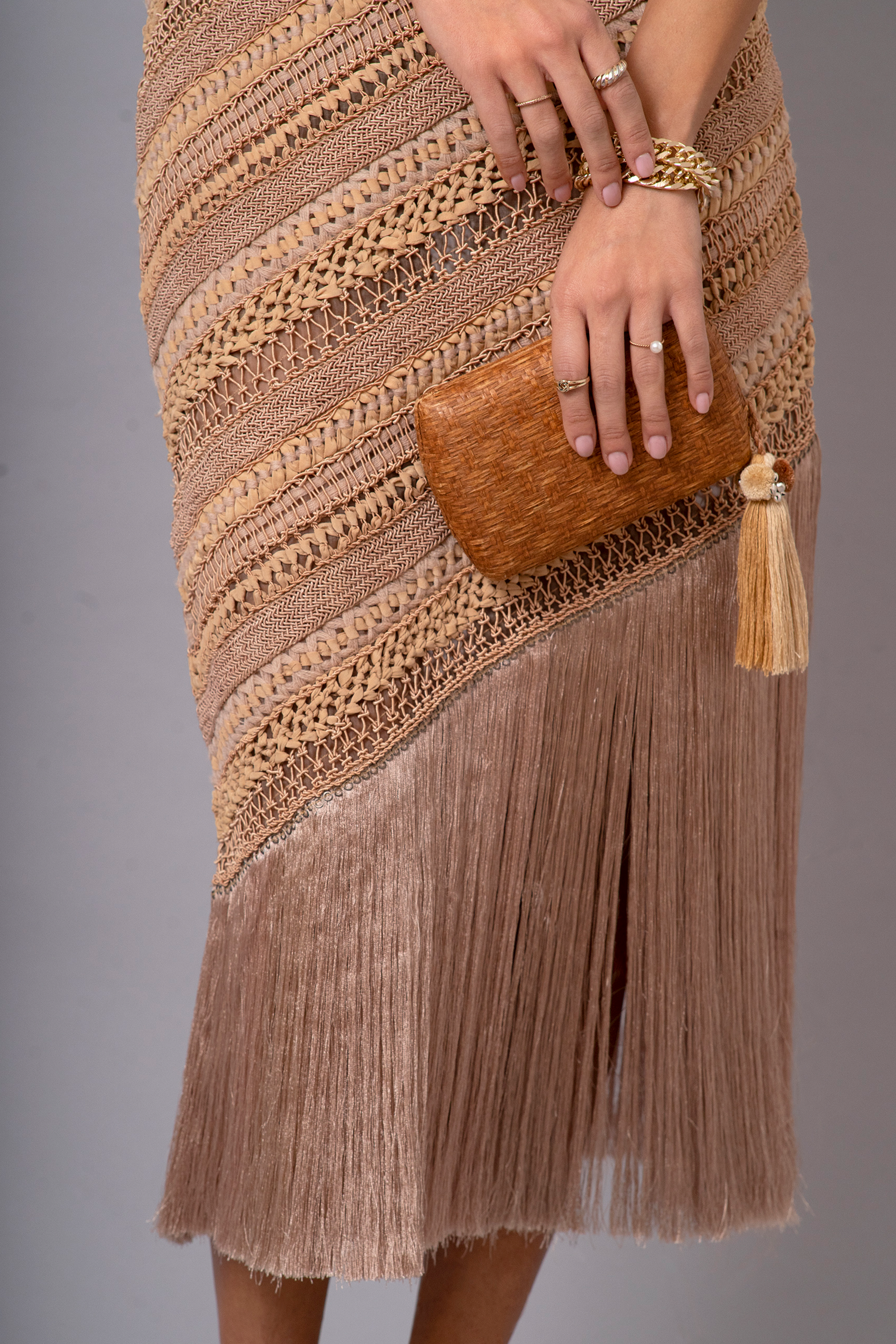 Close-up of full-length view of OCHRIDIA Fringe Skirt in earthy brown with silky fringe detailing.